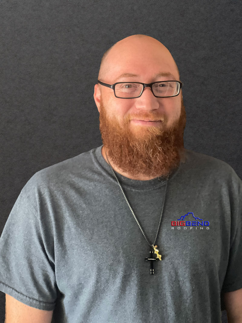 Portrait of our second Roofing Specialist at Big Bend Roofing, standing against a backdrop of a beautifully completed roofing project.