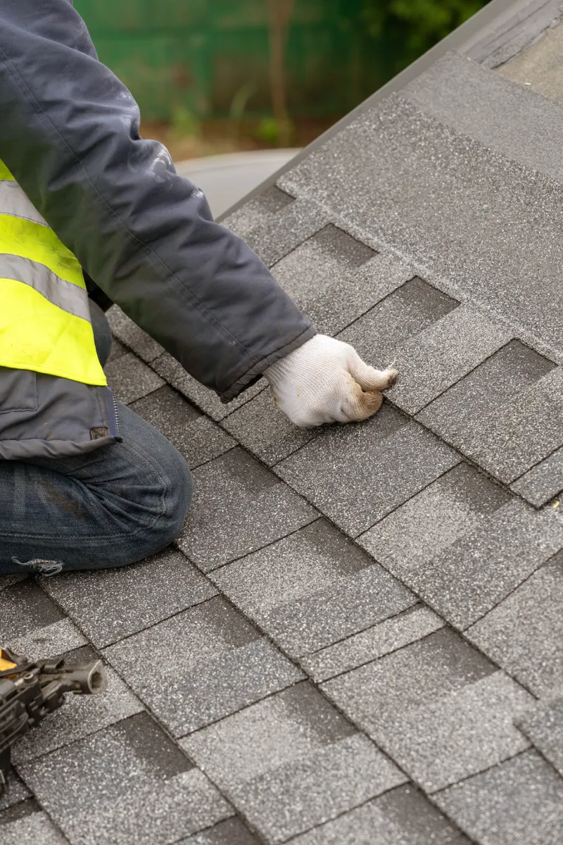 Professional installing Owens Corning Shingles on a residential roof.