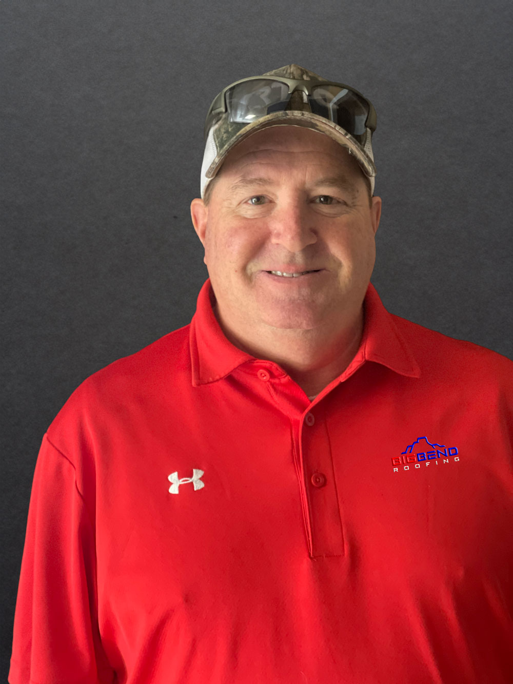 Image of a Roofing Specialist at Big Bend Roofing, with a background of a finished roofing project.