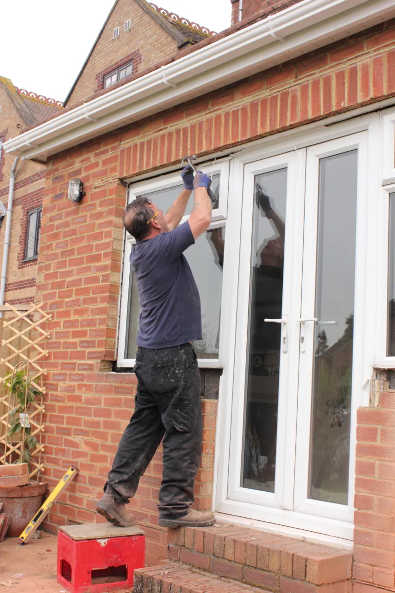 Professional worker installing a modern energy-efficient window.